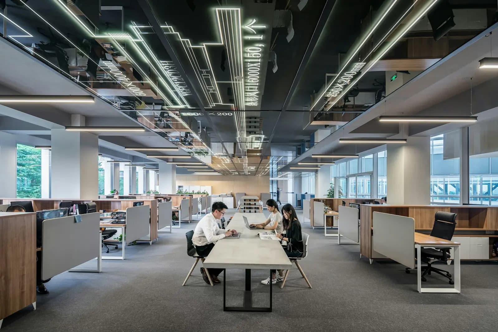 Three colleagues working together in a bright open plan office