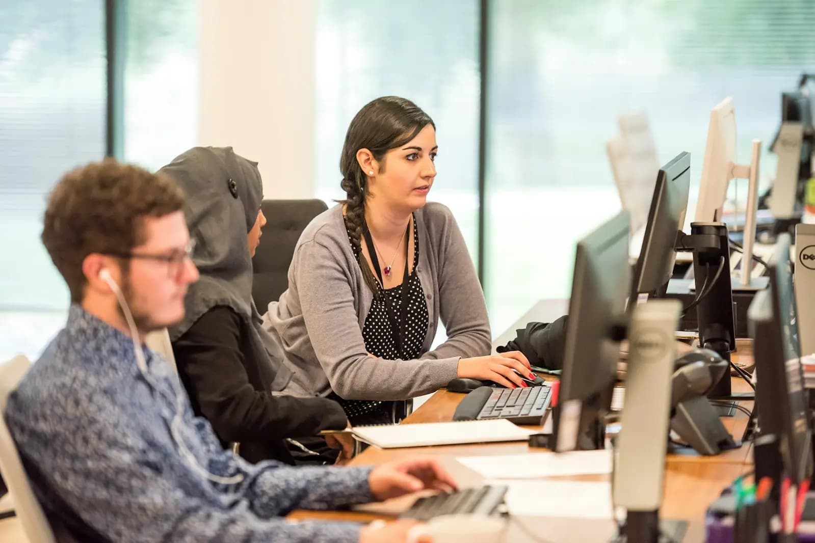 Team members working side by side at their computers