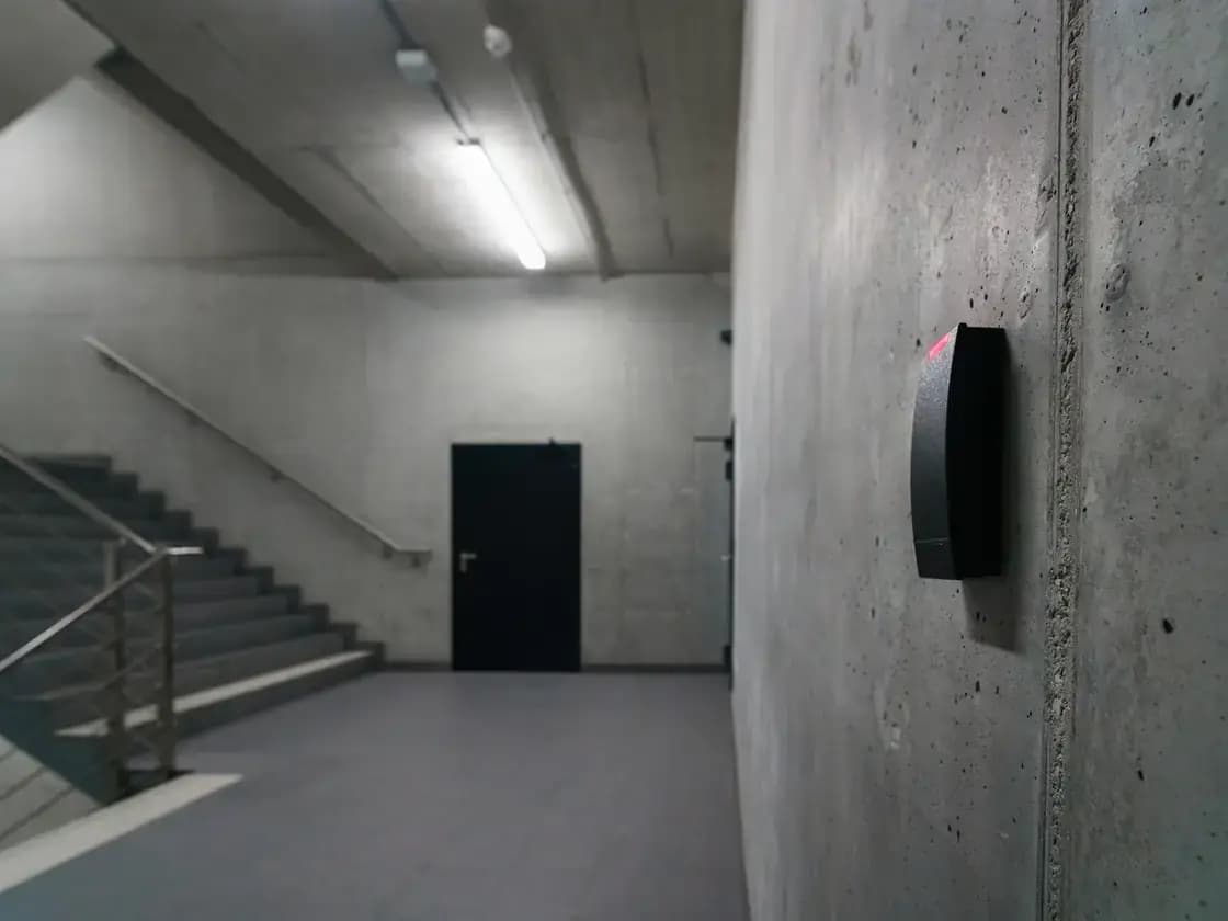An electronic badge reader beside a secured office door