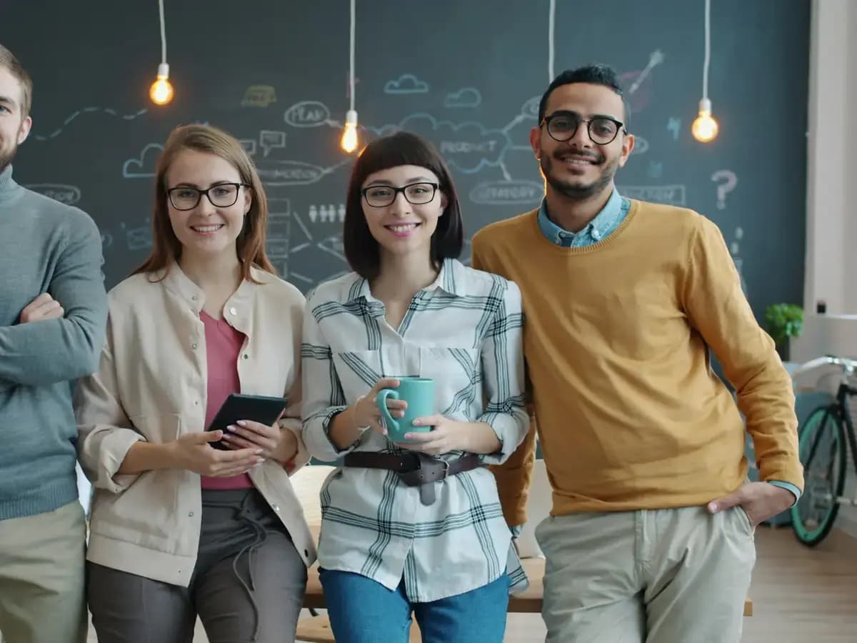 Members of the customer care team standing together in the office
