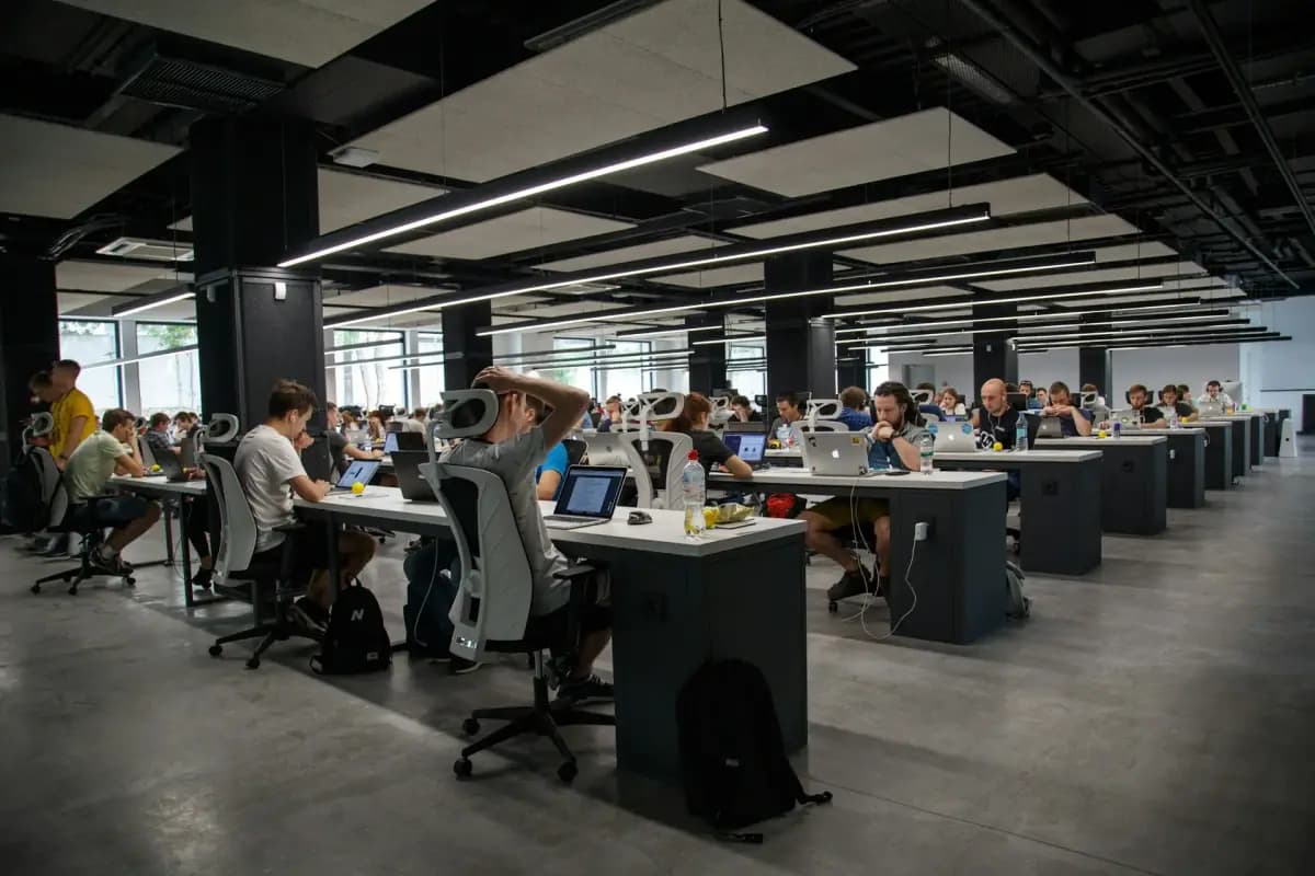A large open plan office with rows of staff at their desks