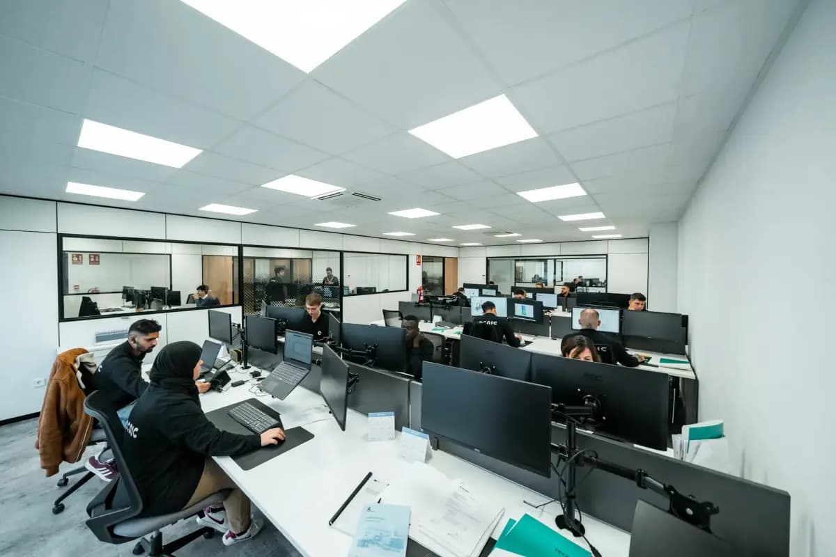A bright operations floor with rows of workstations